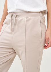 Pants with a seam in the middle and a stone patch