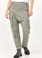 Длинные брюки с зелеными карманами-карго.