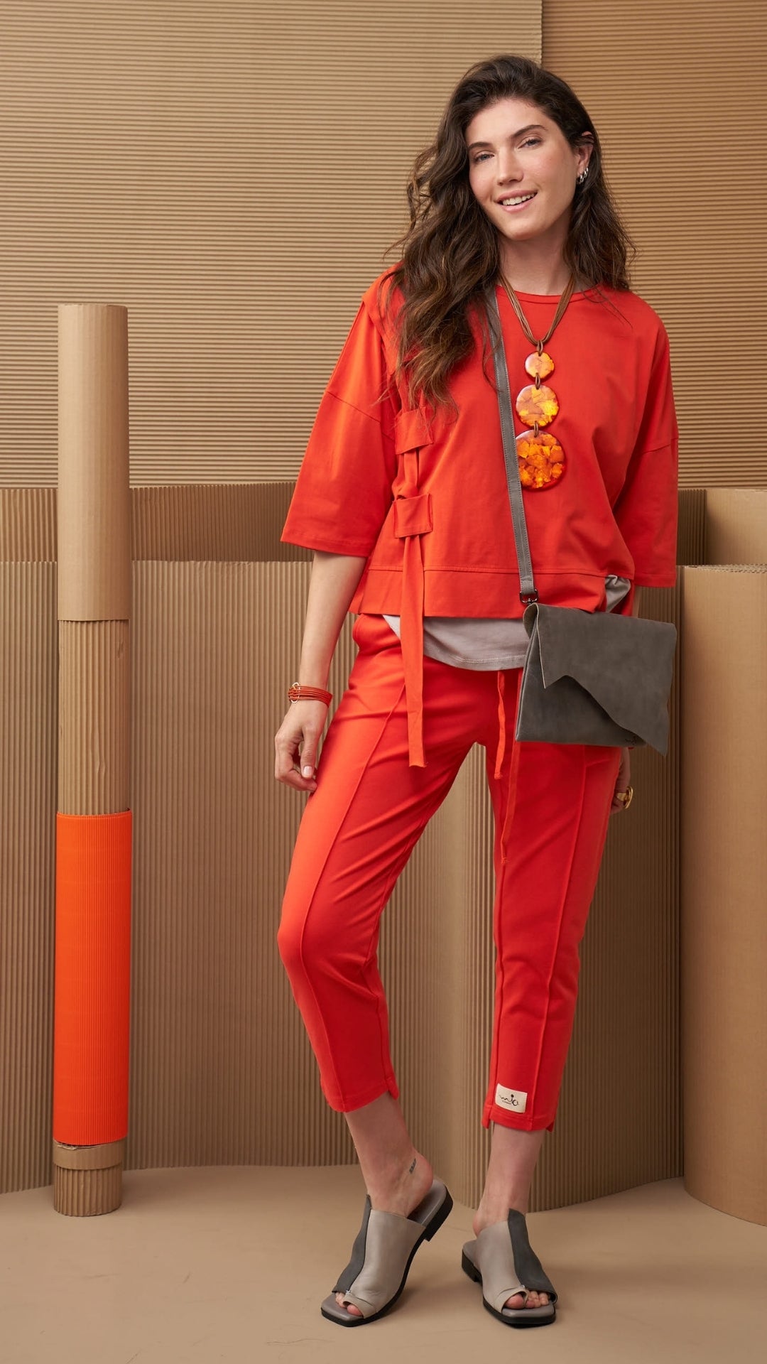 A chain of 3 resin circles on an orange thread