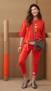 A chain of 3 resin circles on an orange thread