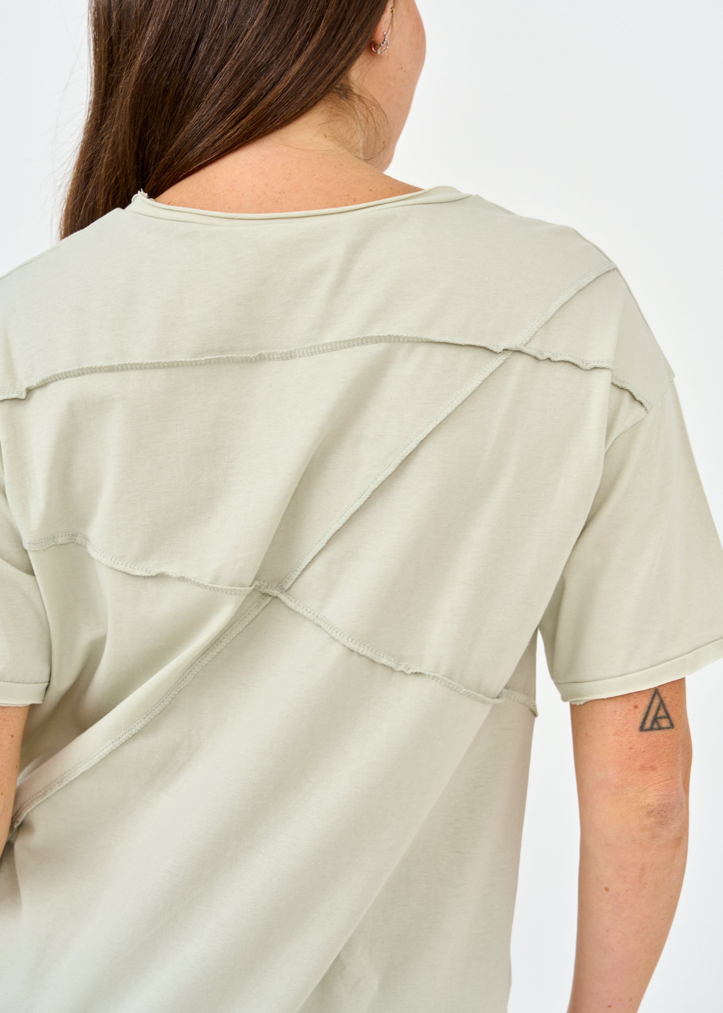 Green short sleeve shirt with prominent cuts