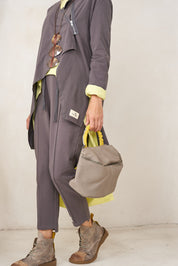 A small leather bag with a handle and a blue color combination