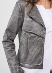 Short jacket with buttons on the back and large pockets on the front, dark gray wash