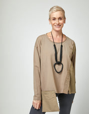 A nylon combination shirt with an exiting front pocket and a brown ribbon