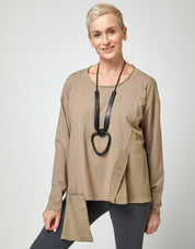 A nylon combination shirt with an exiting front pocket and a brown ribbon