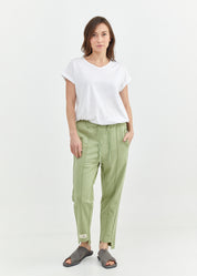 Pants with a seam in the middle and a smoky light green patch