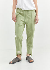 Pants with a seam in the middle and a smoky light green patch