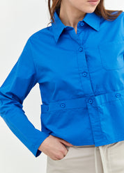 A button-down shirt is getting ready for a blue short