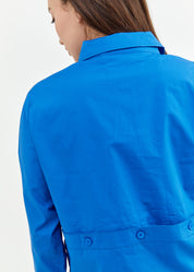 A button-down shirt is getting ready for a blue short