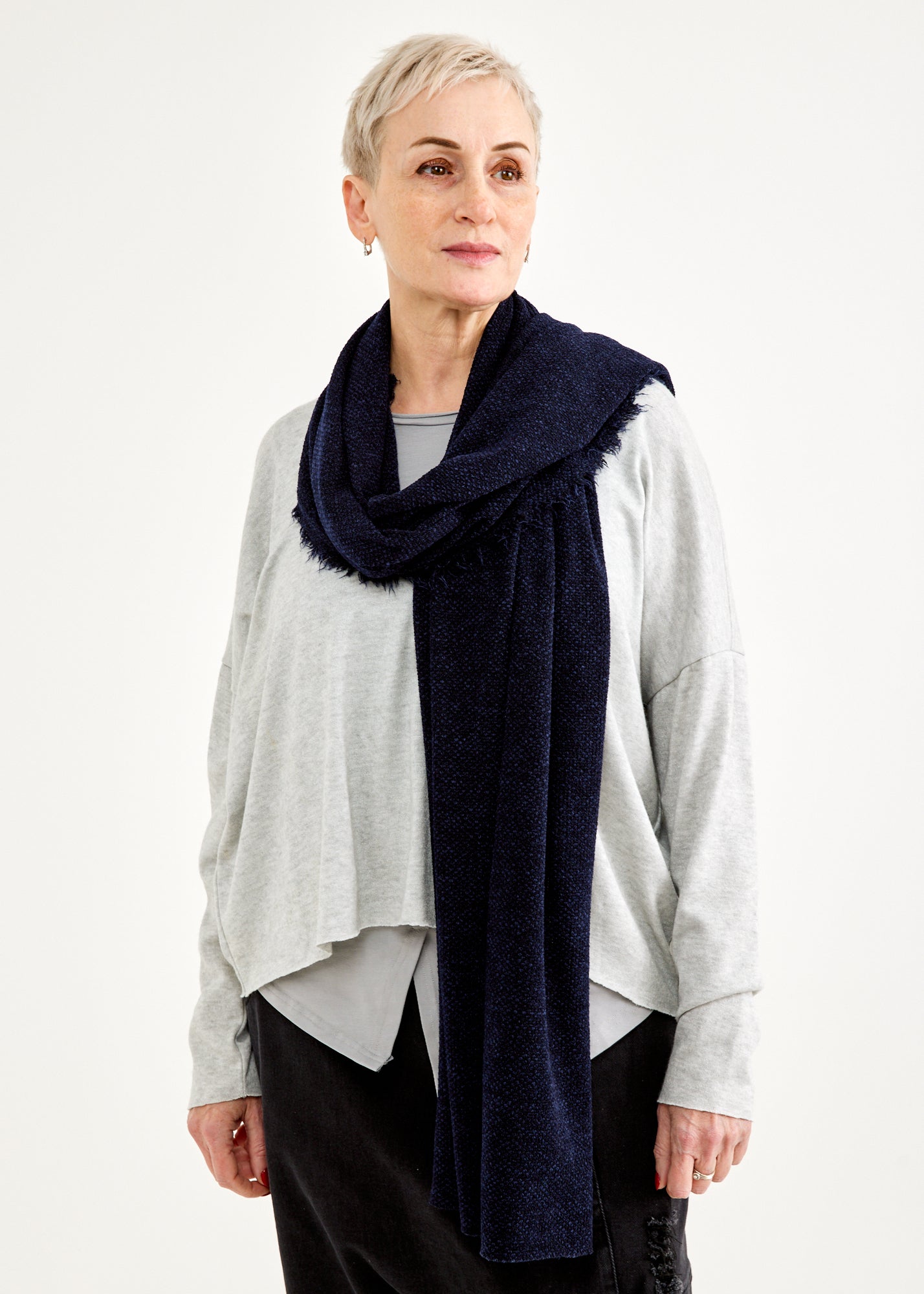 A scarf with a seam in the middle and a blue fringe