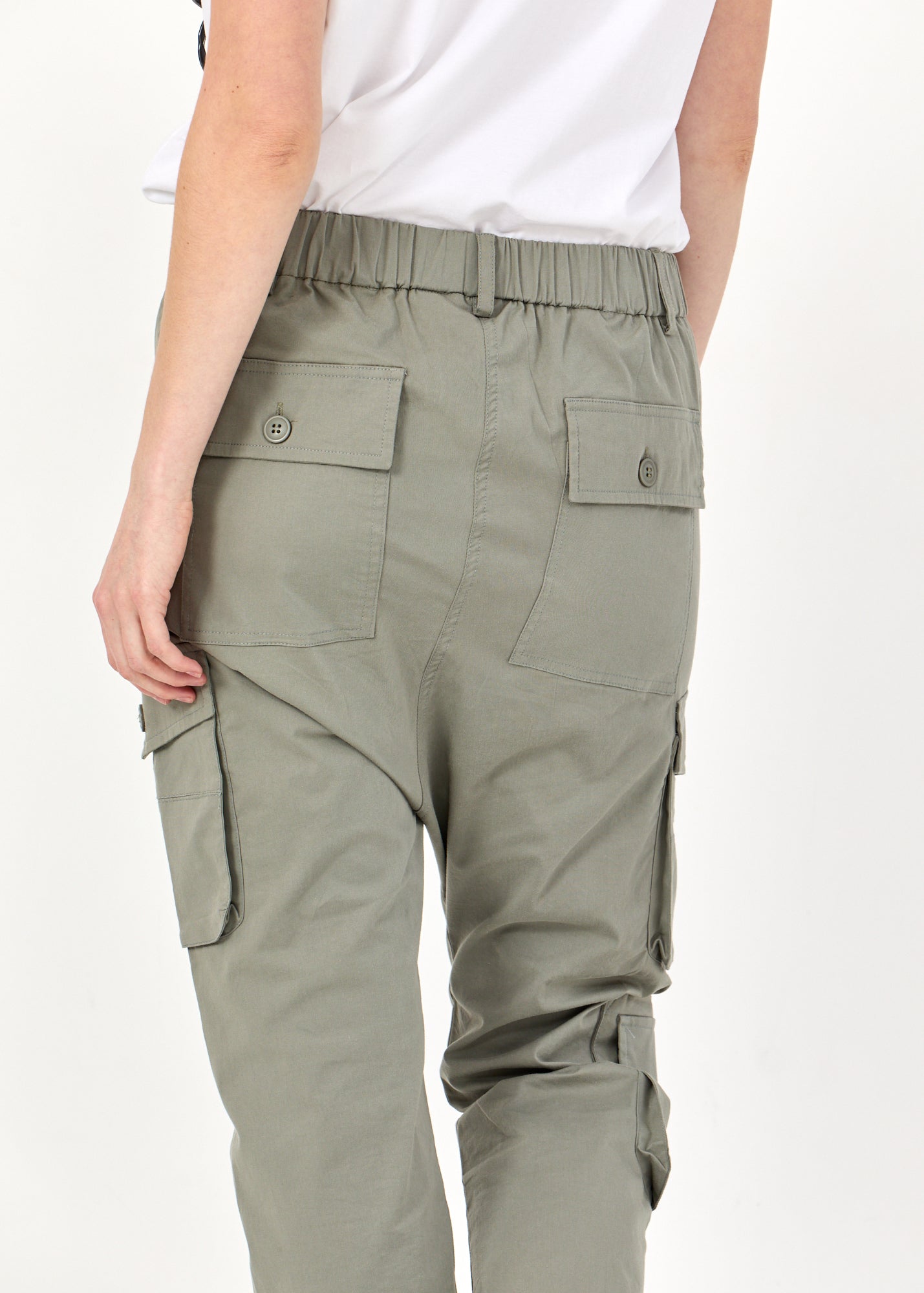 Длинные брюки с зелеными карманами-карго.