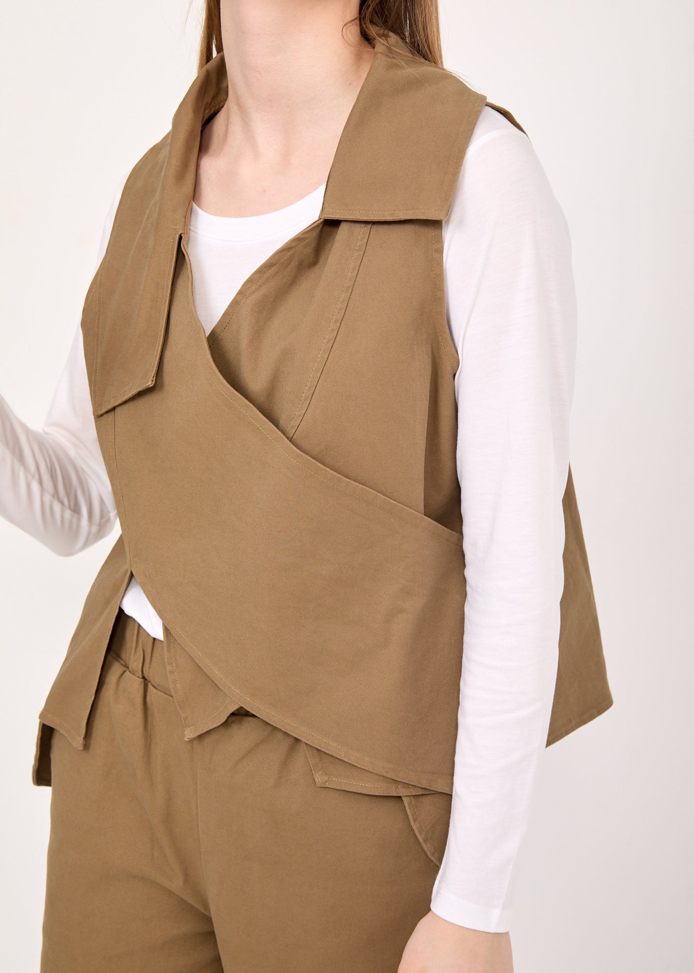 Asymmetric vest with brown button