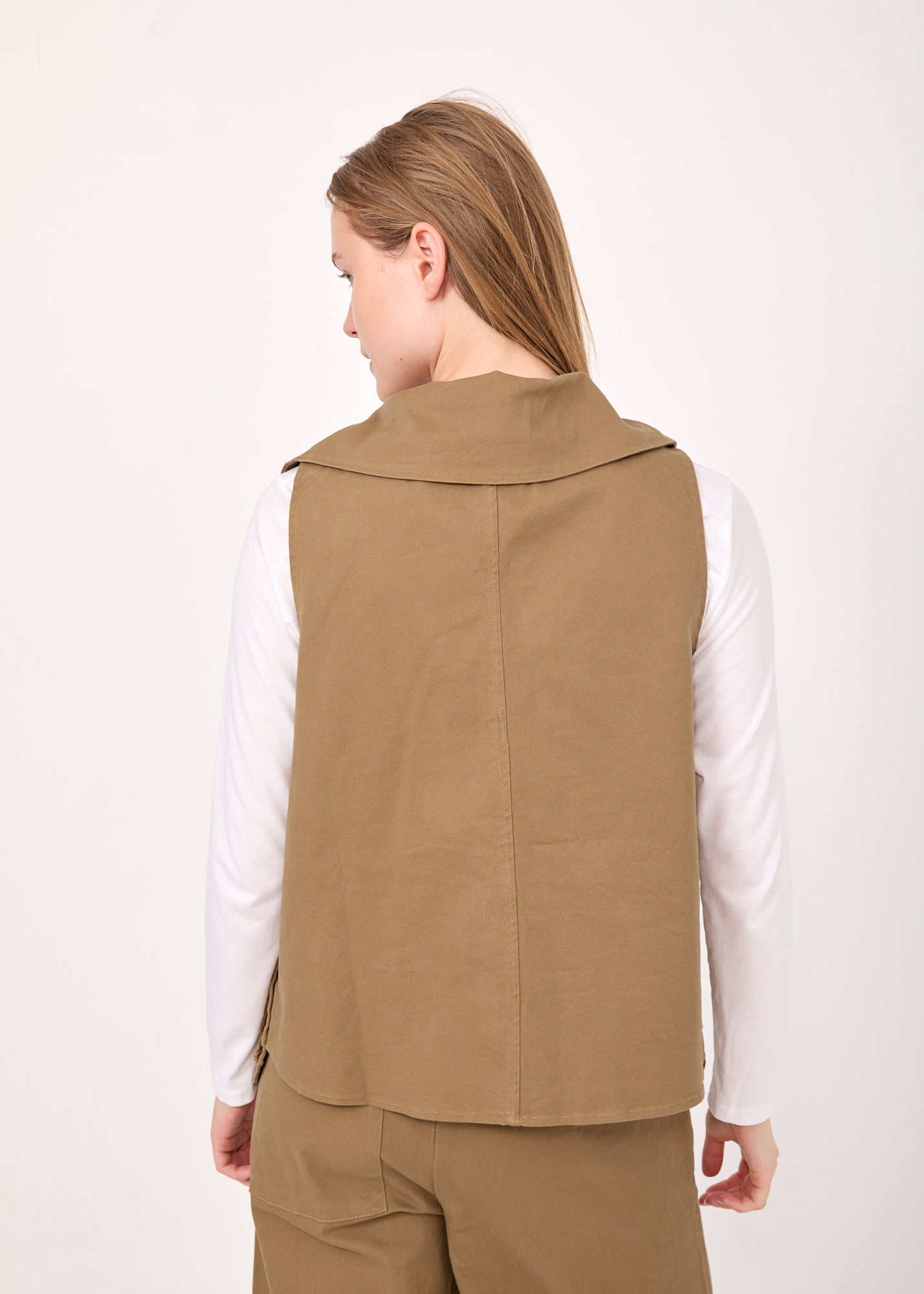 Asymmetric vest with brown button