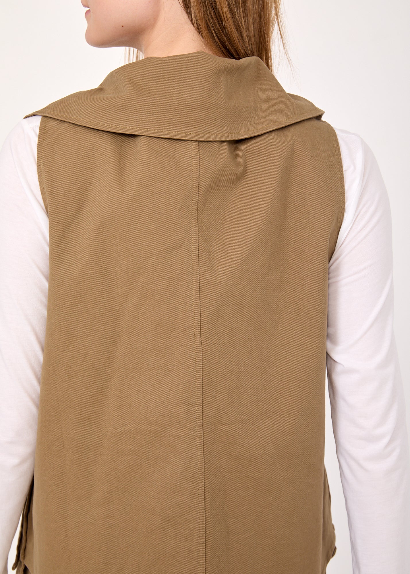 Asymmetric vest with brown button