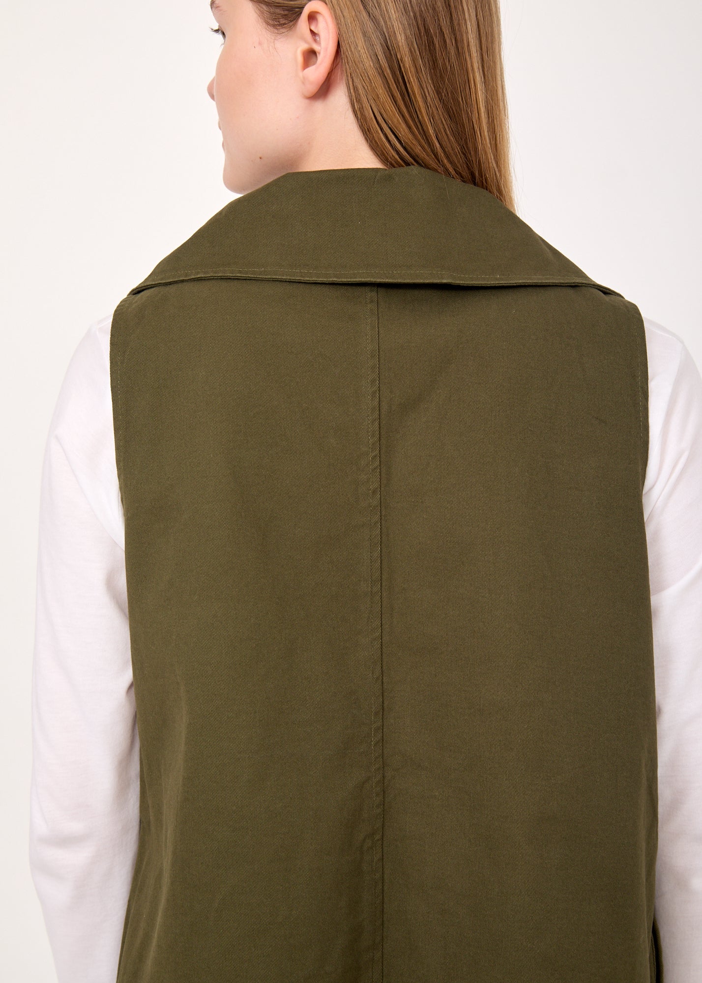 Asymmetric vest with green button