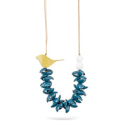 A necklace of painted wooden semicircles and a gray bird
