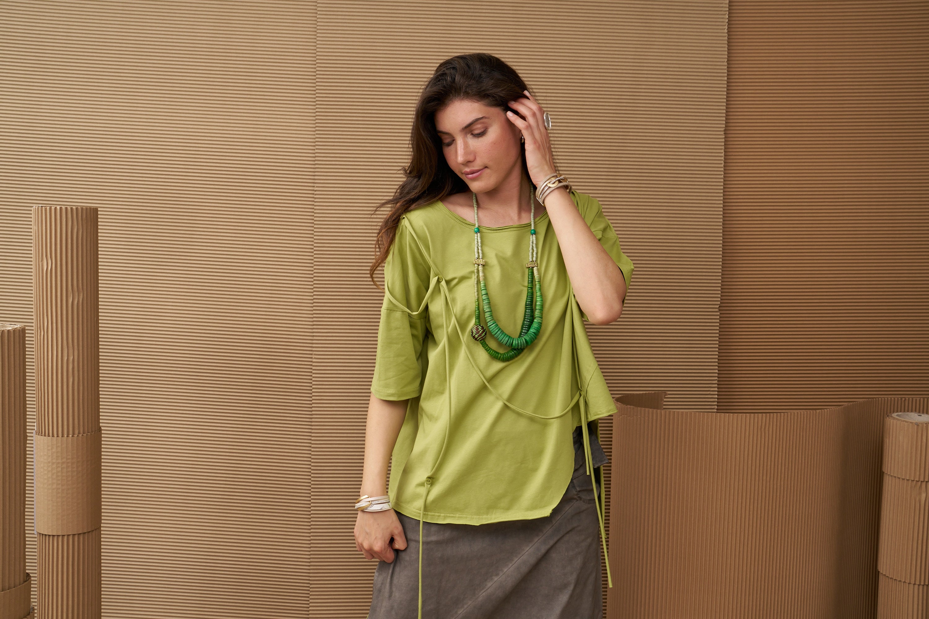 A necklace of coconut disks and a green wrapped bead