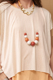 Handmade necklace made of orange wood chip beads
