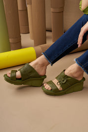 Green leather platform heel shoes with buckle and knot
