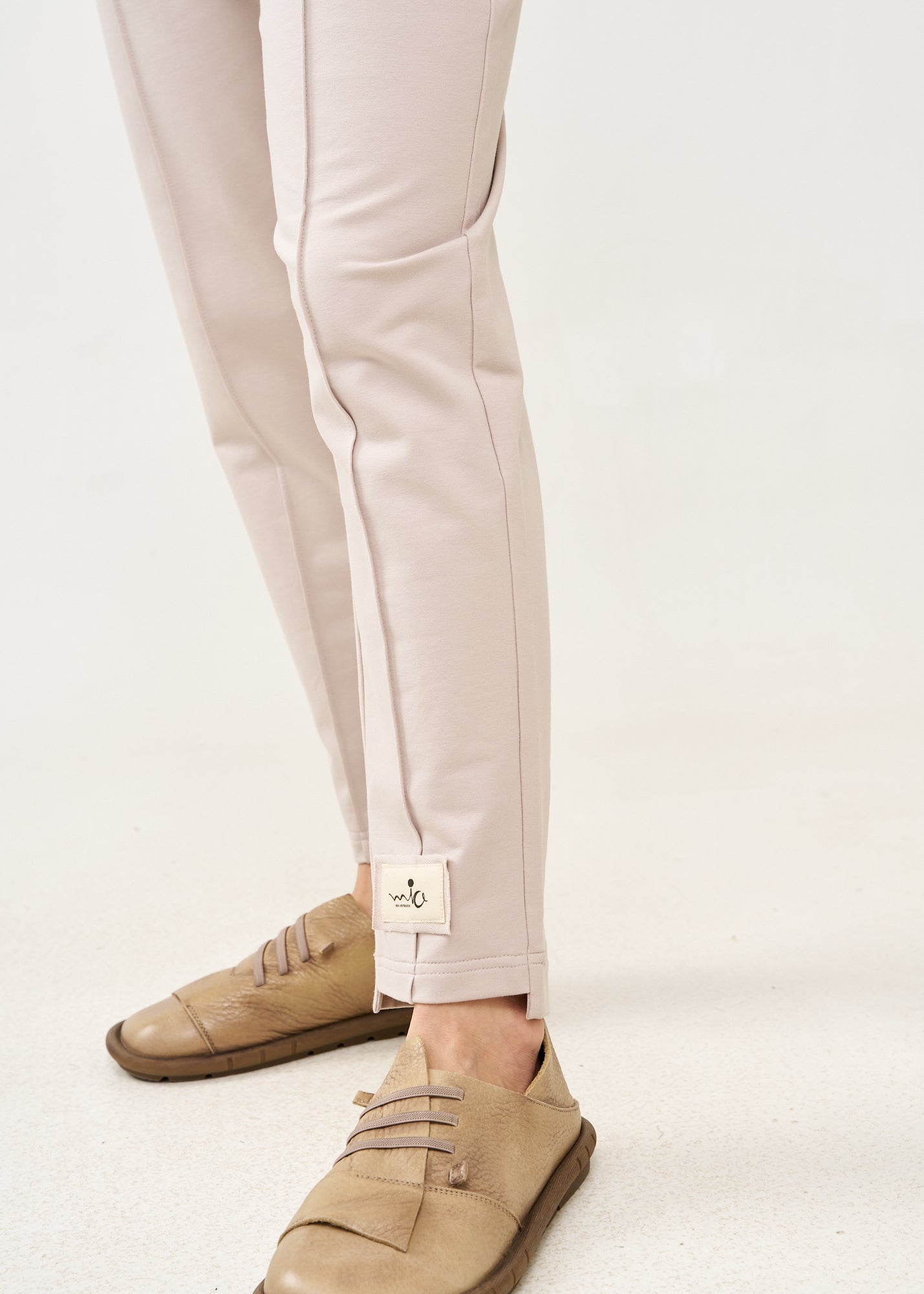Pants with a seam in the middle and a stone patch