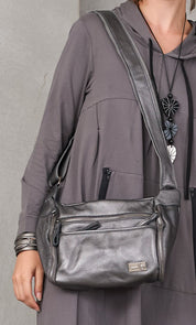 Leather pouch bag with silver side pockets