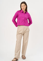 A button-up shirt is getting ready for a purple short