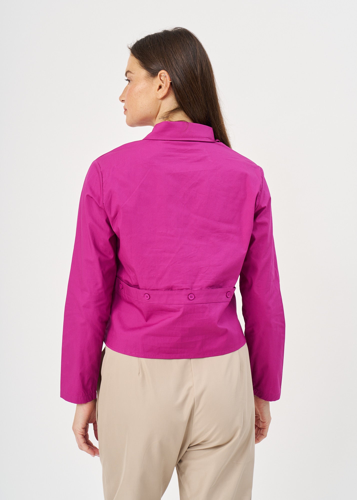 A button-up shirt is getting ready for a purple short