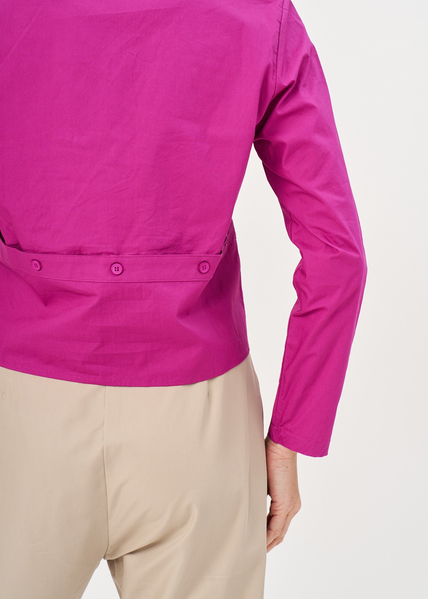 A button-up shirt is getting ready for a purple short