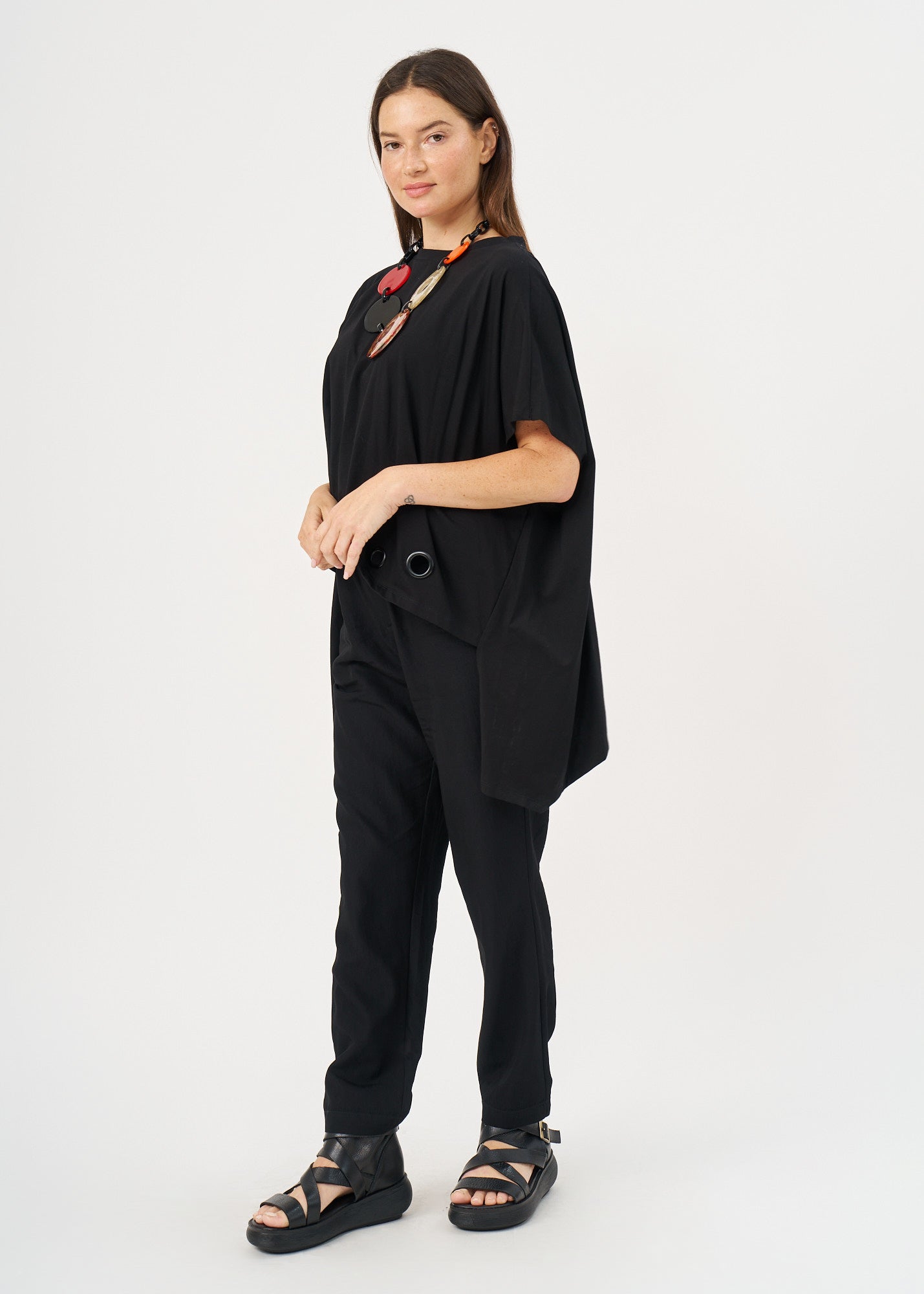 A shirt with no.s that expands on the sides with a black loop