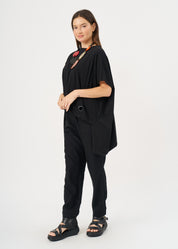 A shirt with no.s that expands on the sides with a black loop