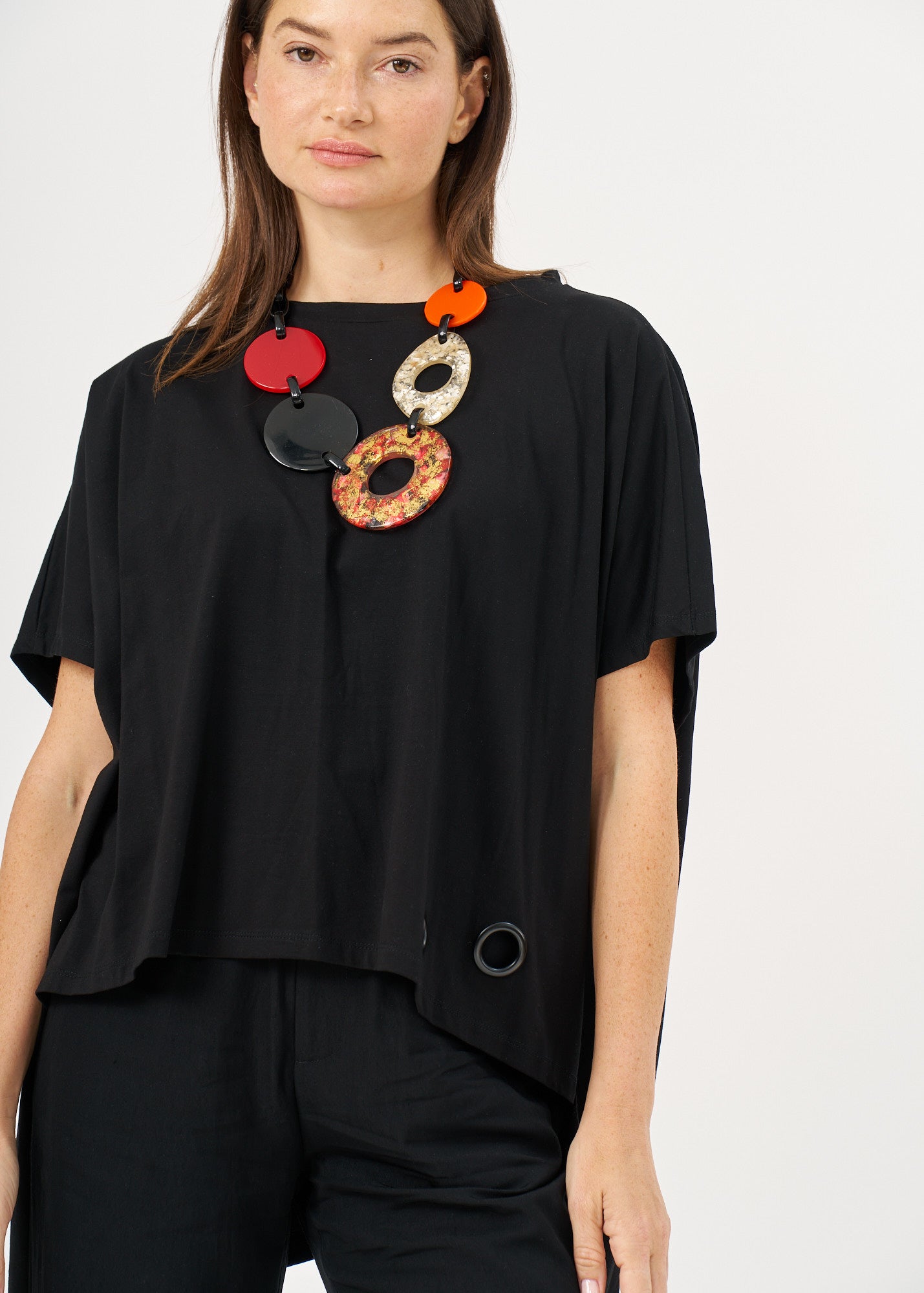 A shirt with no.s that expands on the sides with a black loop
