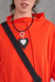 Leather heart necklace on a black leather heart