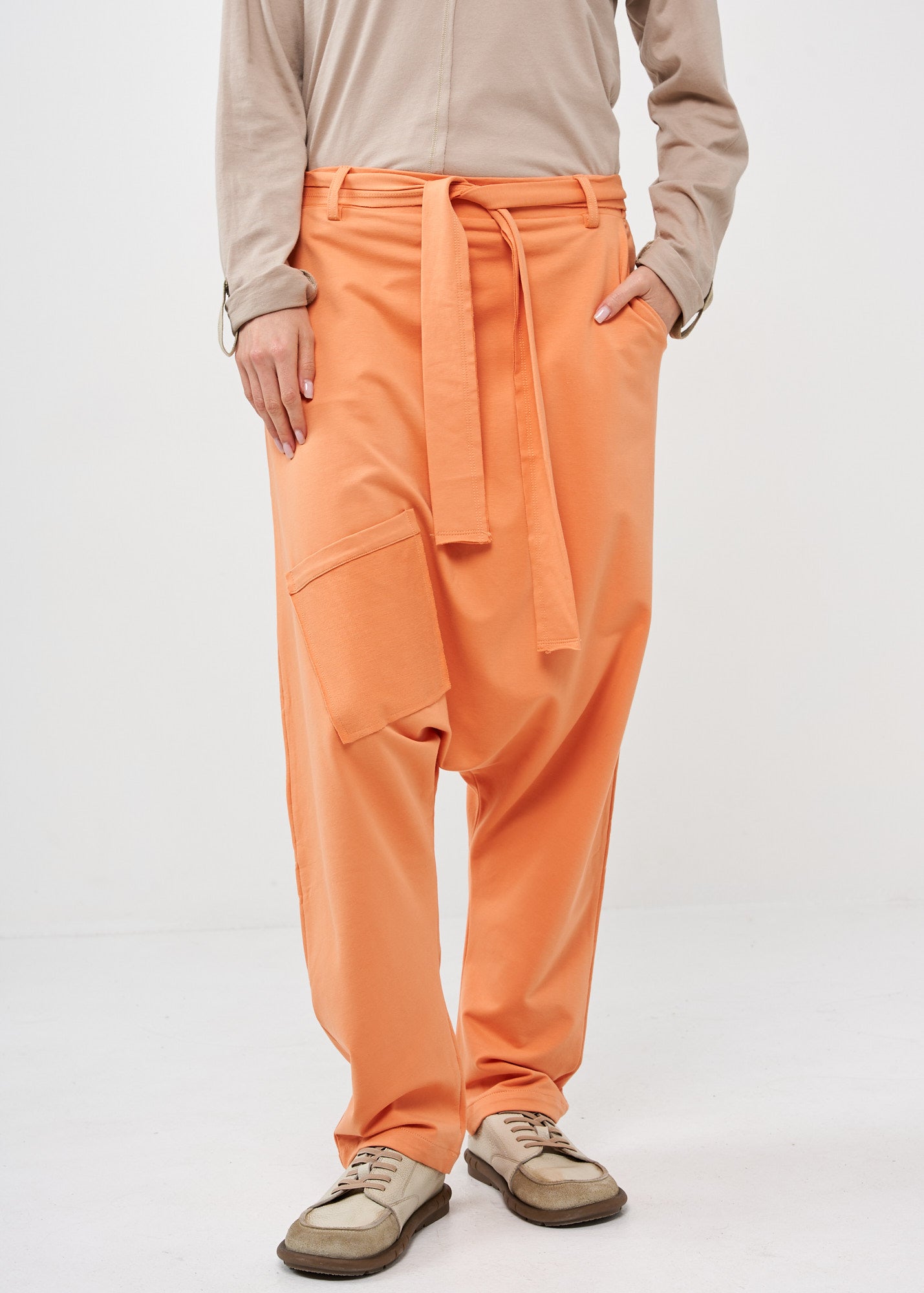 Pants with pockets and an orange belt