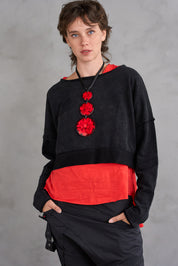 A chain of 3 resin circles on a red thread