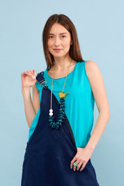 Necklace of painted wooden semicircles and a beige bird
