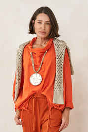 Handmade necklace with threads and a large gold resin circle