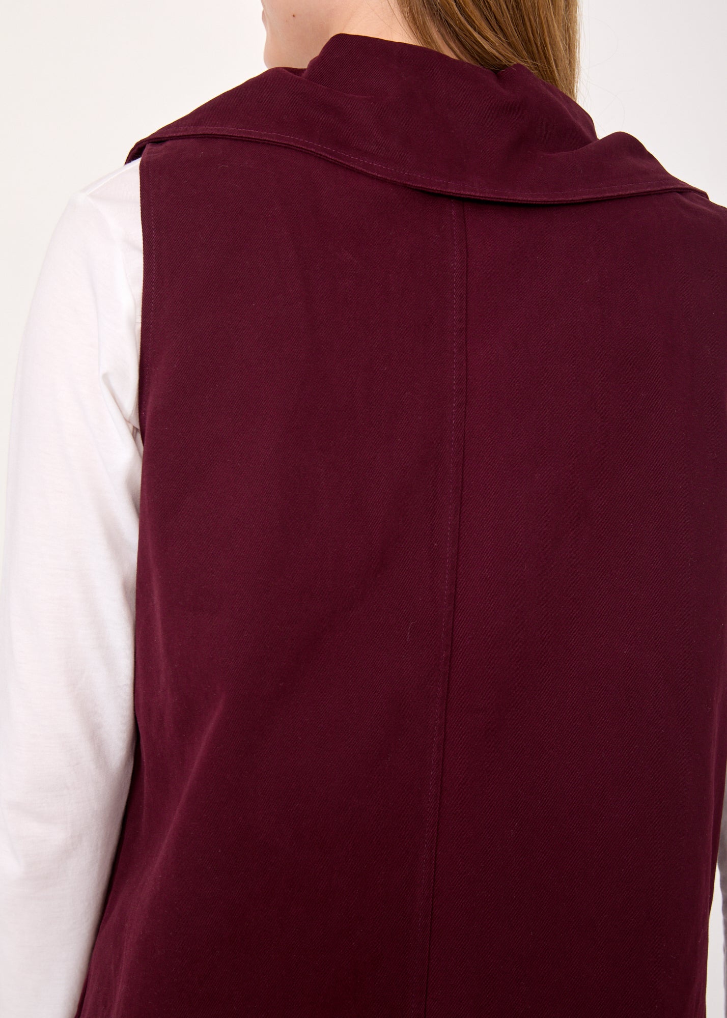 Asymmetric vest with a purple button